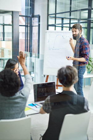 Leadership, presentation and graph in office for meeting, collaboration and data analysis. Teamwork, men and woman in workplace for planning, strategy and start up company project in New Yorkの写真素材