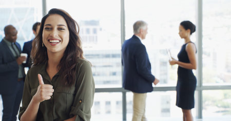 Portrait, employee and woman with thumbs up, happiness and gesture for opinion, approval and office. Sign, agreement and person with smile for vote, finger and positive mindset in company or greatの写真素材