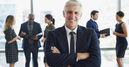 Office, businessman and attorney in portrait with pride, corporate career or legal aid with smile. Confident, mature lawyer or leader with arms crossed for about us, justice or court case at law firmの写真素材