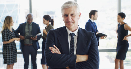 Office, businessman and lawyer in portrait with pride, corporate career or legal aid with smile. Confident, mature attorney or leader with arms crossed for about us, justice or court case at law firmの写真素材