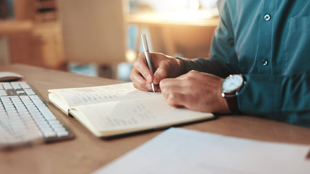 Business person, hands or writing with book at night for reminder, schedule or notes at office desk....