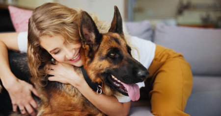 Home, woman and hug for dog, care and affection for german shepherd in living room or rescue animal. Happy, adoption and person with pet in lounge, bonding or love for canine with loyalty in houseの写真素材