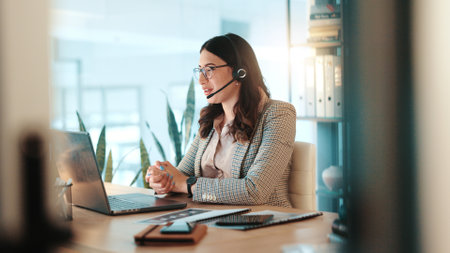 Business woman, consultant and laptop with headset for communication or online advice at office. Female person, employee or agent talking on computer for virtual assistance, app or help at workplaceの写真素材