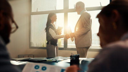 Business people, boss or shaking hands in company for financial achievement, target or profit growth. Investor, office or handshake in meeting for success, deal or well done for investment agreementの写真素材