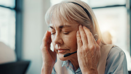 Tired, woman and headache of stress in call center for difficult client, overworked or burnout....