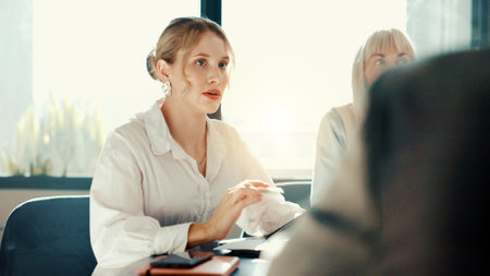 Woman, tablet and discussion at meeting, finance and report for revenue growth with team at office. Person, accounting and staff with insight for review, feedback and audit with planning at agencyの写真素材