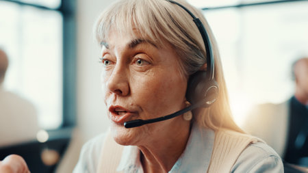 Call center, agent and woman with headset, sales and communication with contact for lead generation. Business, representative and mature person with tech for telemarketing, talking and consultationの写真素材