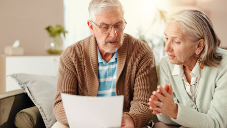 Elderly couple, documents or home with finance on sofa for budget or financial planning together....