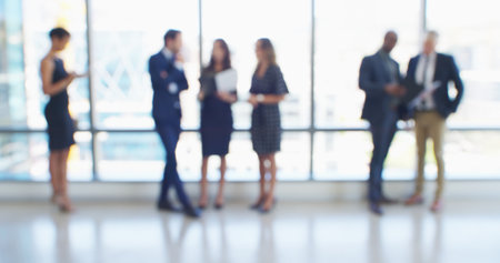 Blur, business people and group in office, conversation and teamwork with accounting. Employees, cooperation and financial advisors in workplace, economy analyst and diversity with discussionの写真素材