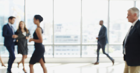 Blur, busy and walking with business people in lobby of office for corporate productivity. Moving, window and work with professional employee group in convention center for development seminarの写真素材