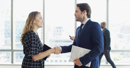 Handshake, welcome and meeting with business people together for proposal document. Greeting, partnership and B2B deal with employee shaking hands for introduction, corporate seminar and networkingの写真素材