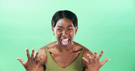 Surprised, portrait and woman with smile, studio and reaction for good news, happy and mockup space. Green background, wow and black person with facial expression, shocked and excited for opportunityの写真素材