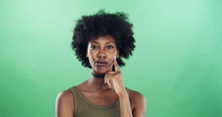 Thinking, portrait and black woman in studio with ideas, decision or brainstorming for university. Problem solving, mockup space and African female student with choice for college by green backgroundの写真素材