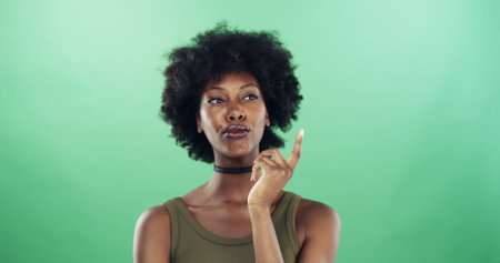 Thinking, choice and black woman in studio with ideas, decision or brainstorming for university. Problem solving, mockup space and African female student with planning for college by green backgroundの写真素材