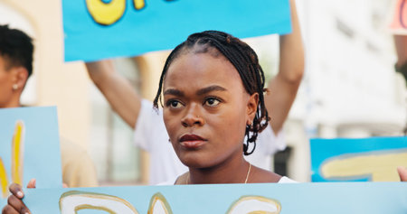 Angry, rally and woman with poster in city for announcement, human rights and power. People,...