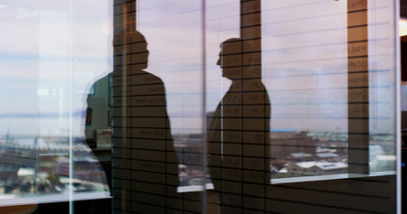 Businessmen, silhouette or window with reflection on balcony for corporate insight or travel. Team, employees or company spectrum with vision for negotiation or discussion on economic infrastructureの写真素材