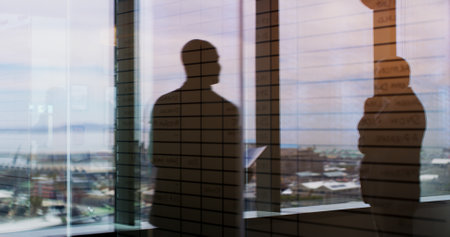 Business people, silhouette and window with reflection on balcony for corporate insight or travel. Colleagues, employees or double exposure with vision for negotiation on economic structure in cityの写真素材