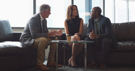 Business, finance and people with meeting in lobby for financial compliance, oversight or planning. Analysts, team and happy with discussion for budget review, risk management and revenue forecastingの写真素材