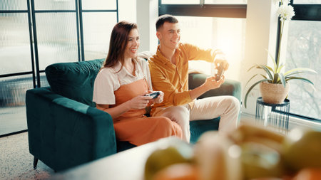Challenge, having fun and gamer couple on sofa in home living room together for bonding or dating. Competition, remote control and video game with happy people in apartment for online entertainmentの写真素材