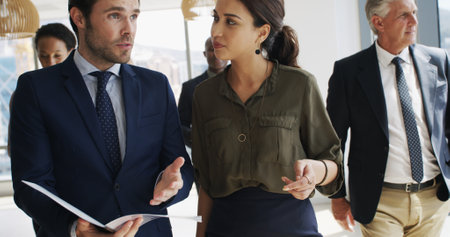 Business, people and file with talking in office for case preparation, feedback and testimony. Law firm, lawyers and teamwork with paperwork for legal justice, lawsuit advice and strategy developmentの写真素材