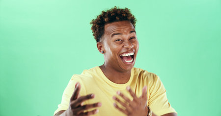 Comic, funny or laughter with black man on green background in studio for humor, joke and meme....