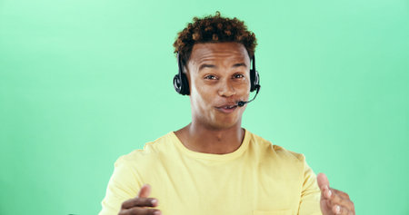 Happy, headset and african man talking in studio for call center, telemarketing and green...