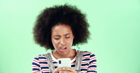 Green screen, disappointed and black woman with phone for breaking news and online scam. Mockup...