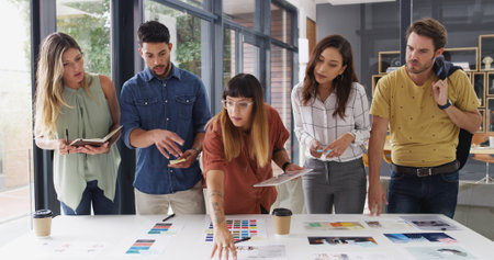 Business people, teamwork and tablet with brainstorming, creative project and color palette with app. Group, employees or graphic designers in office, cooperation and tech with proposal or discussionの写真素材