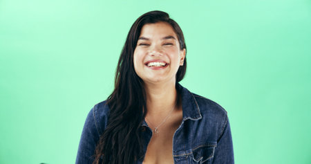 Smile, woman and portrait of teacher in studio with confidence for education career with ambition. Happy, mockup space and educator from Thailand with pride for creche school job by green background.の写真素材