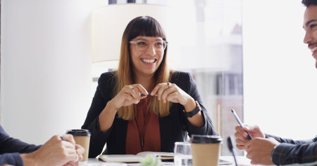 Meeting, employees and businesswoman with smile in office, talking and creative expansion in agency. Boardroom, staff and startup manager with cooperation for discussion, feedback and team of writersの写真素材