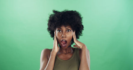 Black woman, surprise and gasp in studio portrait for deal, announcement or sale by green...