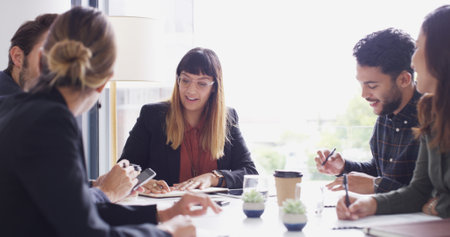 Collaboration, meeting and notes with business people in boardroom for discussion or planning. Corporate, teamwork and writing with employee group in office together for professional workshopの写真素材