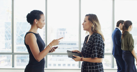 Business women, discussion or meeting with notebook by window for corporate development or growth....