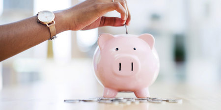 Hand, piggy bank and coin for saving, money and financial growth for wealth expansion in office....