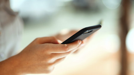 Person, hands or typing with phone for ecommerce, online payment or shopping app on bokeh. Closeup,...