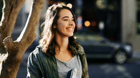 Happy woman, tourist and travel in city street for funny sightseeing, adventure or outdoor journey. Female person, photographer or tourism with smile for new destination or location in urban townの写真素材