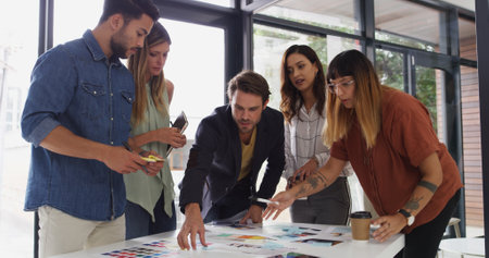 Office, business people and teamwork with talking for color swatch, creative agency and decision. Boardroom, women or men as graphic designer with palette for brainstorming, company branding or pointの写真素材