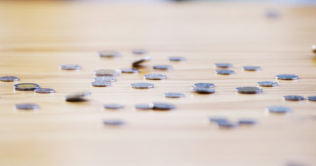 Economy, money and coins on table for investment, interest and finance growth in closeup....
