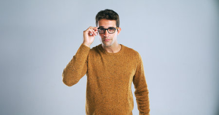 Glasses, optometry and portrait with man in studio for eye test, frame fitting or vision correction. Eyewear, lenses or prescription with model on white background for ophthalmologist appointmentの写真素材