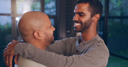 House, hug and gay couple with dance, smile and happy with relationship and romance or support. Night, apartment and queer people with lgbtq, bonding and marriage for commitment or late love emotionの写真素材