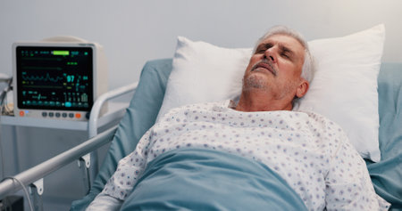 Healthcare, recovery and sleep with old man in hospital bed for rest from operation or surgery. Emergency, insurance and tired with senior patient in medical clinic for rehabilitation from accidentの写真素材