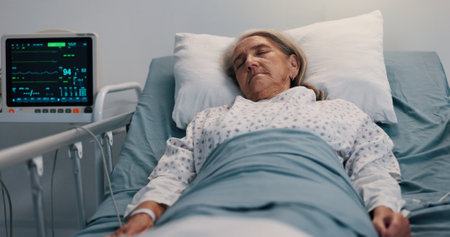 Healthcare, recovery and sleeping with old woman in hospital bed for rest from operation or surgery. Insurance, medical and tired with senior patient in clinic for rehabilitation from accidentの写真素材