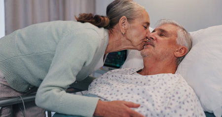 Senior woman, man and kiss in hospital bed for care, love or support for healing in retirement....