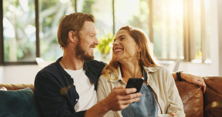 Happy, phone and couple on sofa laugh for online meme, internet joke and humor in home. Dating,...