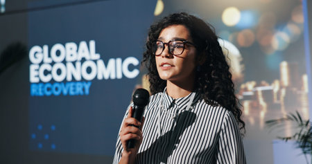 Meeting, speaker and woman with mic, serious and speech for global economic recovery and motivation....