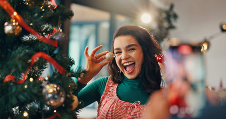 Christmas, tree and picture with woman and bauble for festive season, memory and decoration. Merry...