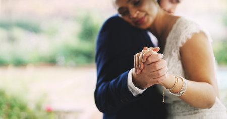 Dancing, couple and celebration for wedding, outdoor and people with love for commitment or romance. Embrace, man and bonding with woman on special day, space and together on weekend for marriageの写真素材