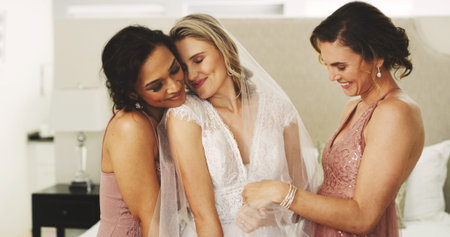 Hug, wedding and friends with bride in bedroom for celebration, support and bridal party. Love, marriage ceremony and bridesmaids or women in home for getting ready, tradition and happiness for eventの写真素材