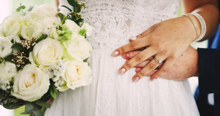 White roses, wedding and couple holding hands for love, care or support at event. Bouquet, man and...