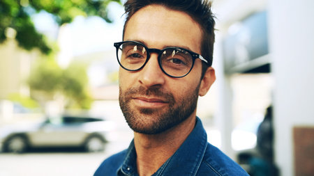 Vision, glasses and portrait of man in city for eye care, optometry and health. Prescription lenses, optical frames and ophthalmology with male person outdoor for spectacles, retina and wellnessの写真素材